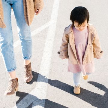 baby wearing shoes to walk with mom