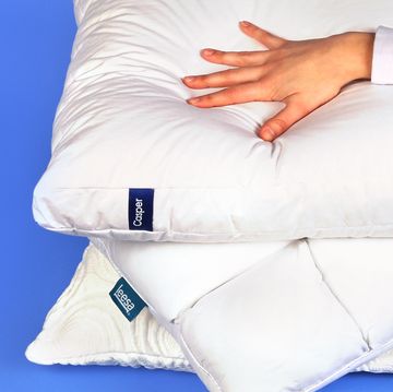 best tested hand pressing down on bed pillows