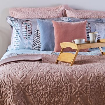 styled bed with pink quilt pillows and tray styled bed with pink quilt pillows and tray