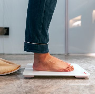 man standing in pajamas on digital scale man standing in pajamas on digital scale