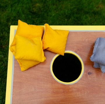 above view of a cornhole game with yellow and gray beanbags above view of a cornhole game with yellow and gray beanbags