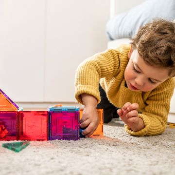 three year old boy playing with magnetic tiles three year old boy playing with magnetic tiles