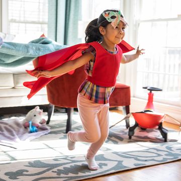 girl playing in superhero cape and butterfly mask girl playing in superhero cape and butterfly mask