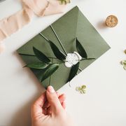 green modern recycled paper wedding invitation on white background