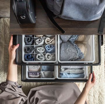 woman opening organized drawers in closet woman opening organized drawers in closet