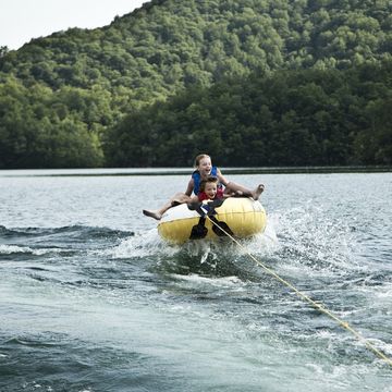 Kids on tube behind boat. kids on tube behind boat