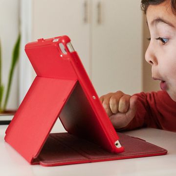kid playing with tablet in red case kid playing with tablet in red case