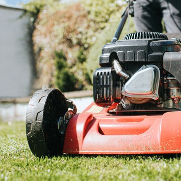 man pushing lawn mower