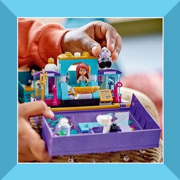 child playing with little mermaid lego playset