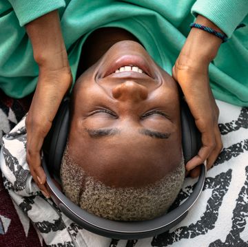 person with headphones listening to music on floor