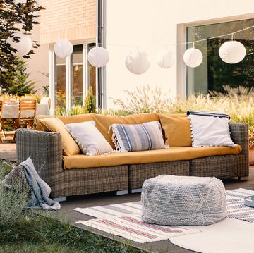 bohemian outdoor living setup with couch pouf carpets and table