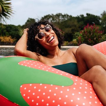 woman floating in strawberry pool float woman floating in strawberry pool float