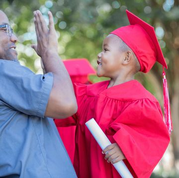 preschool graduate giving high five to dad