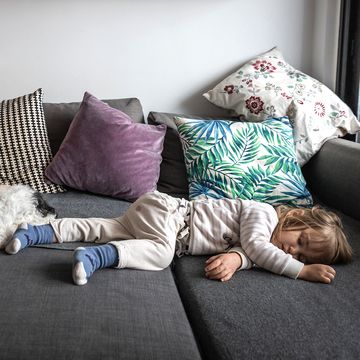 kid and dog asleep on sleeper sofa
