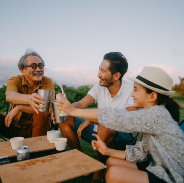 family having a toast at campsite at dusk