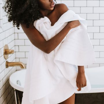 woman toweling off in bathroom